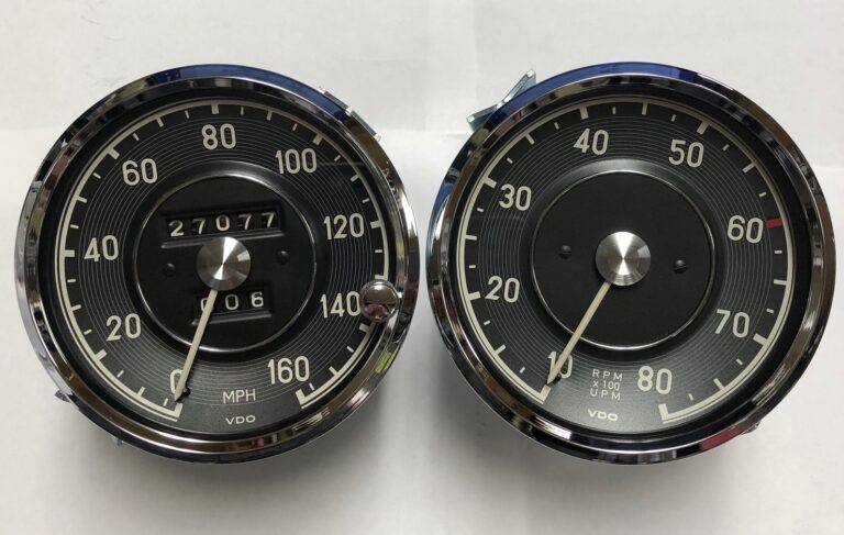 Matched pair of restored instruments, a speedometer reading to 160 mph beside a tachometer, both in chrome bezels.